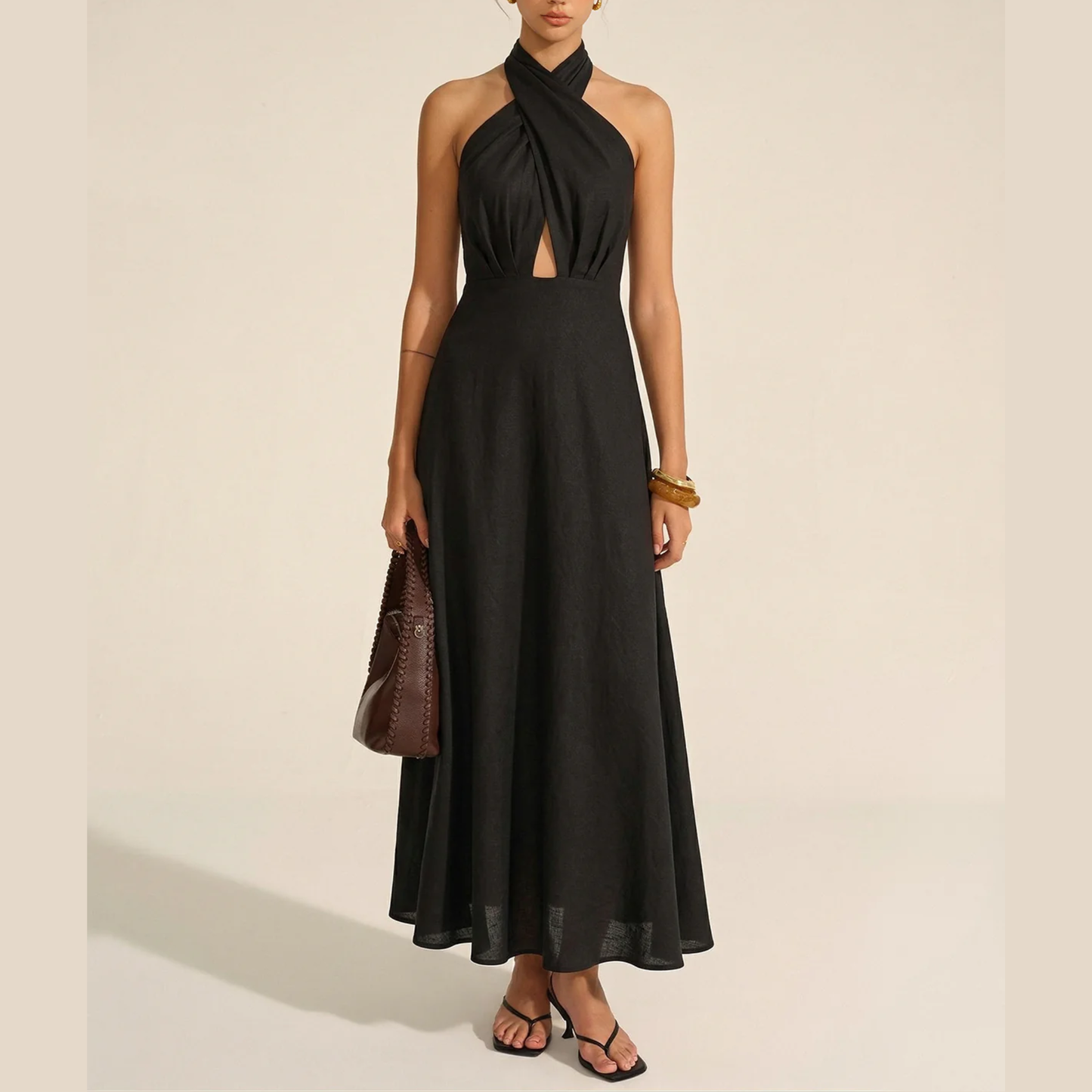 a model wearing the commense black linen halterneck maxi dress from closet concierge