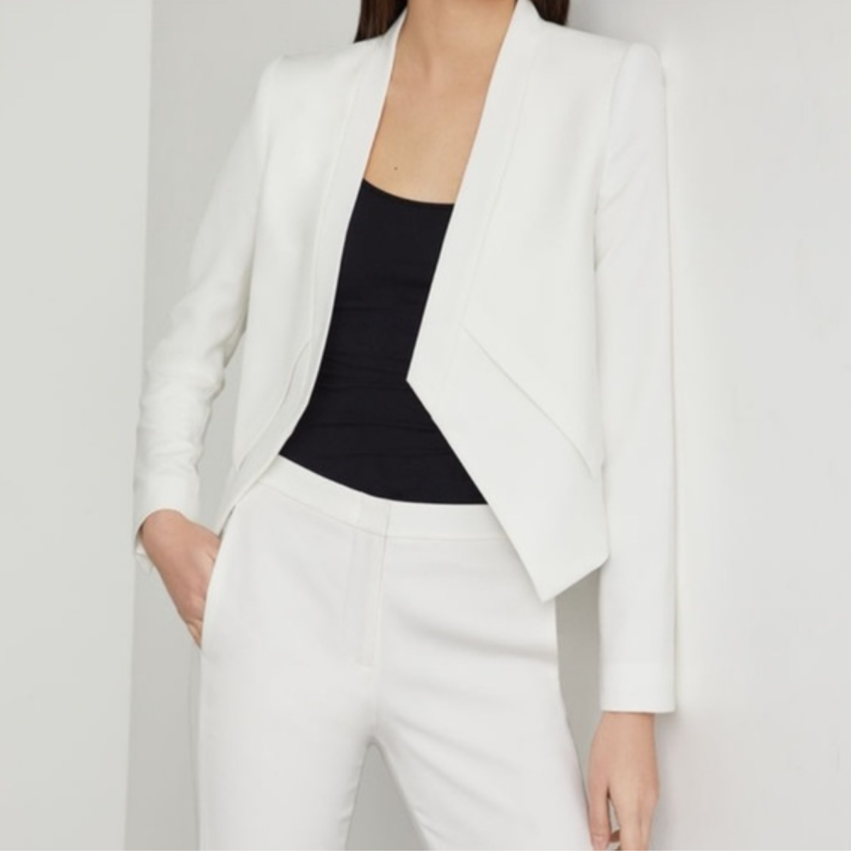 a model wearing the BCBGMaxazria White Blazer from Closet Concierge