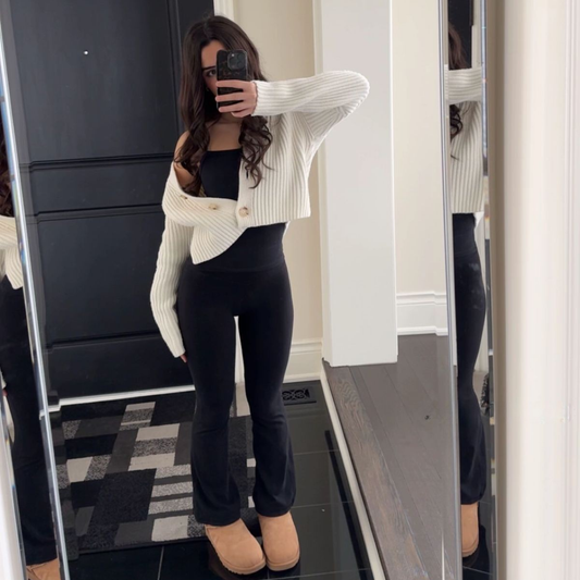 a model wearing the Bershka Black Ribbed Flares from Closet Concierge