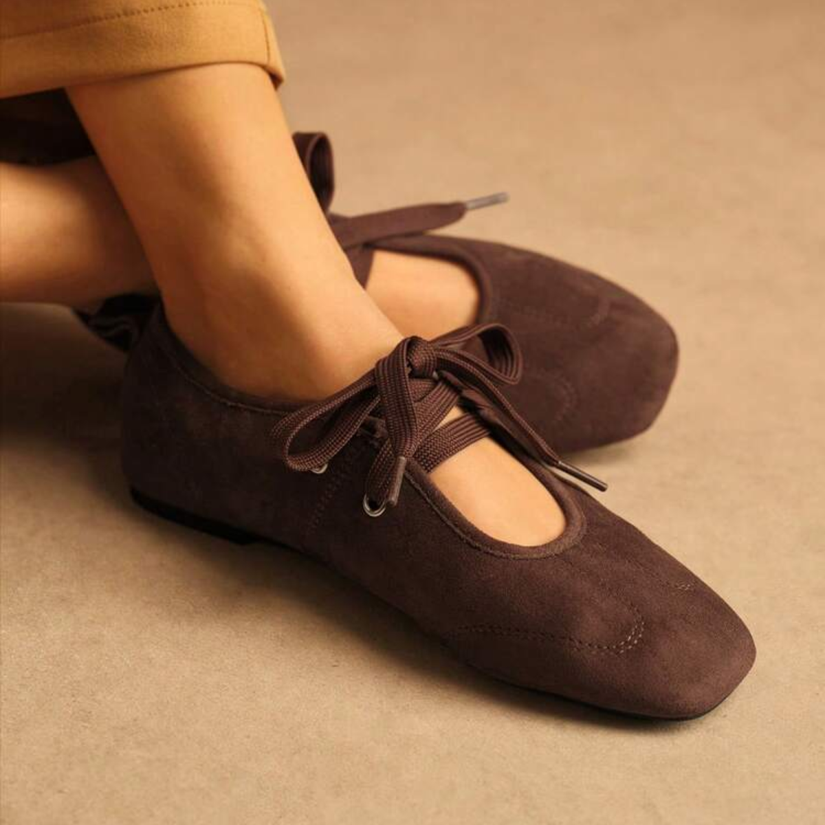 a model wearing the Brown Suede Lace Up Shoes from Closet Concierge