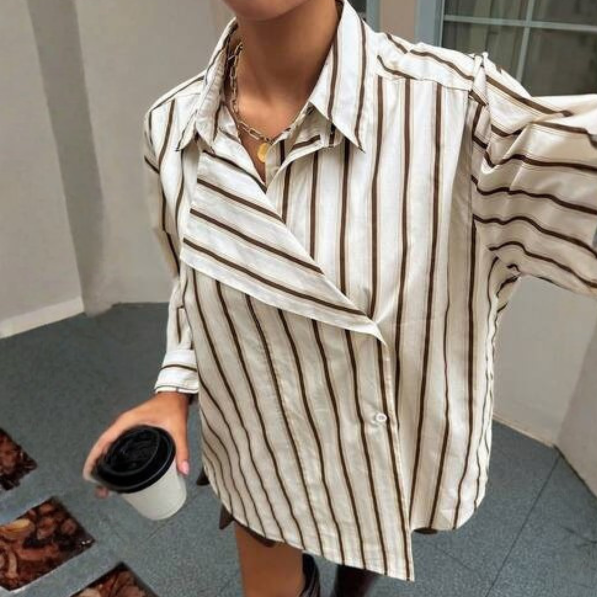 a model wearing the Dazy Asymmetric Striped Shirt from Closet COncierge