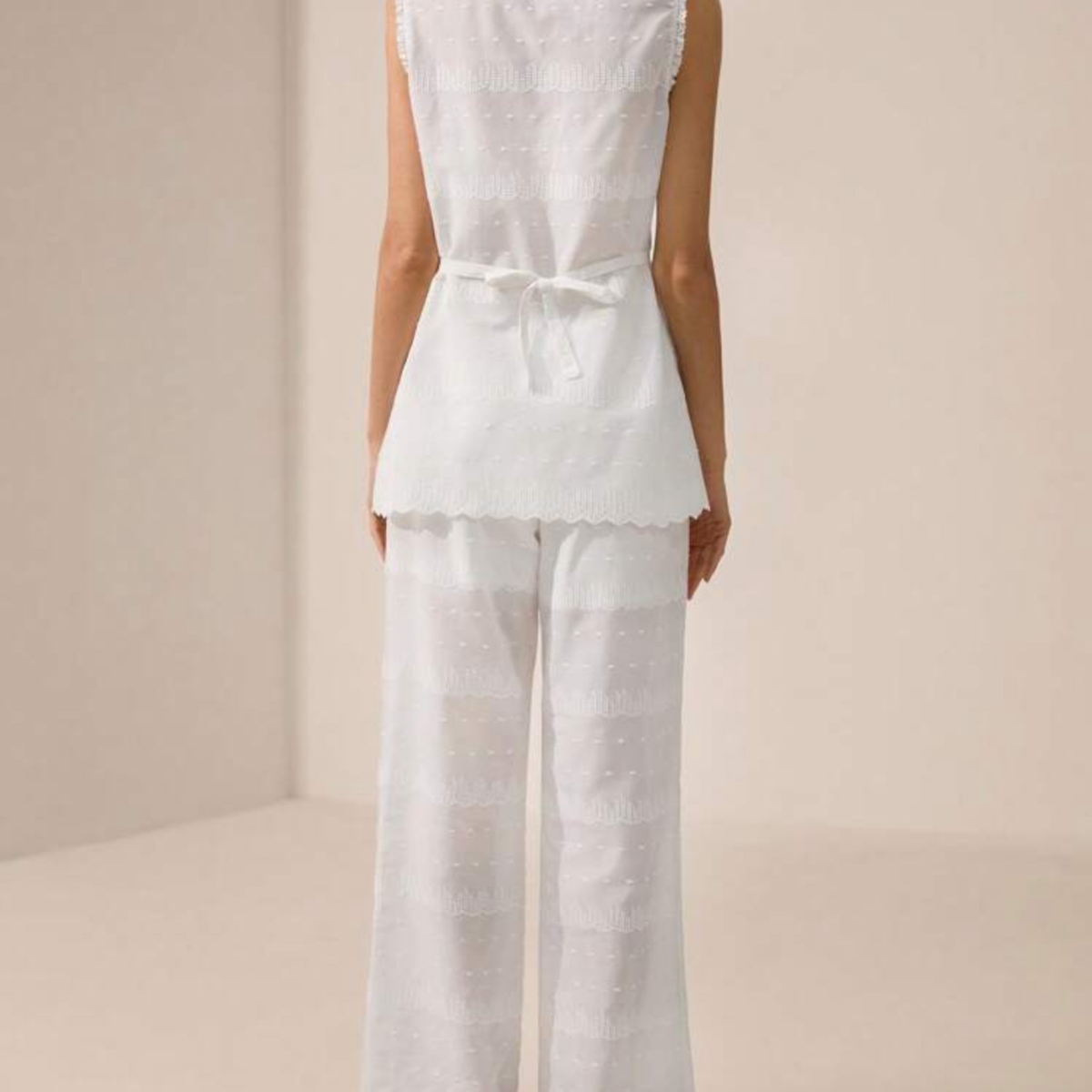 a model wearing the Embroidered White Co-Ord from Closet Concierge shown from the back 