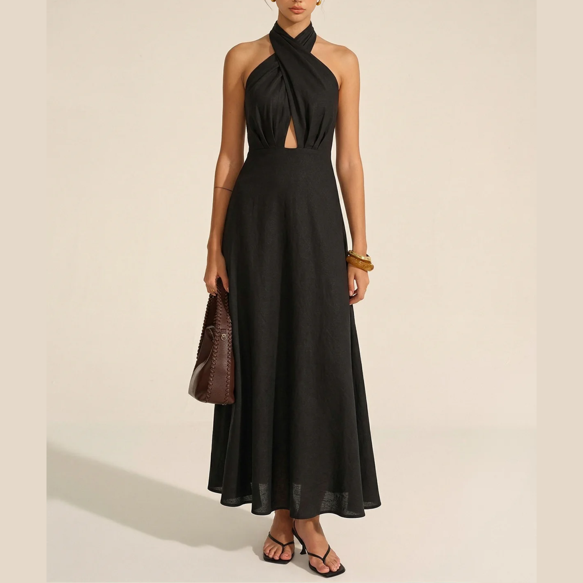 a model wearing the commense black linen halterneck maxi dress from closet concierge