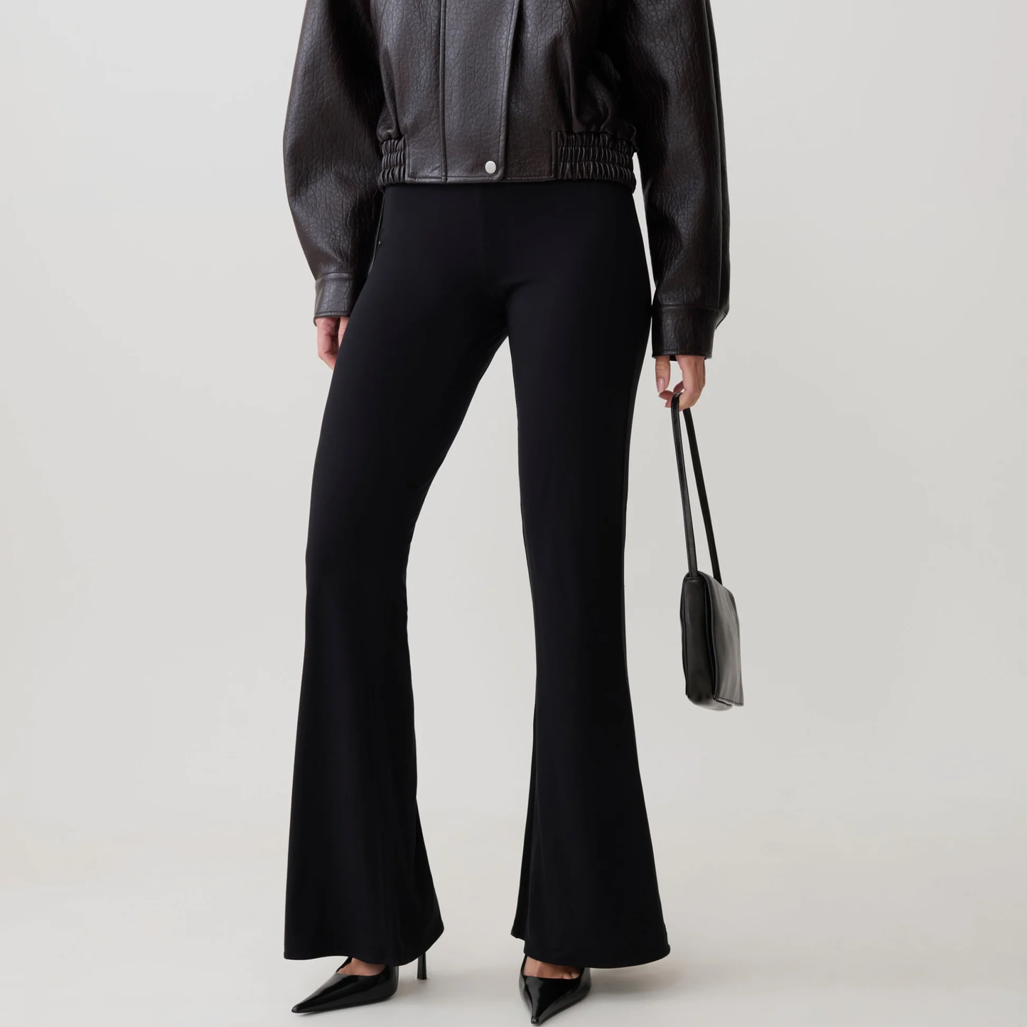 Woman wearing black flares mesh pants from closet concierge 